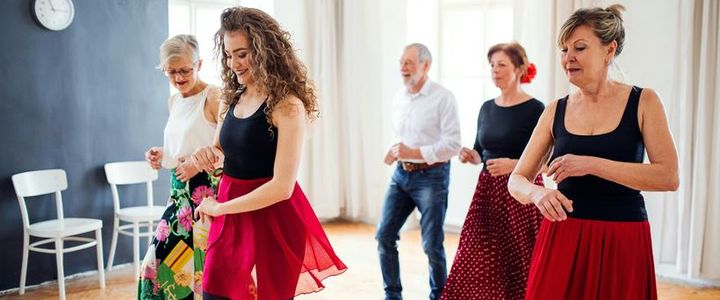 A dance class mid turn, mirrored wall