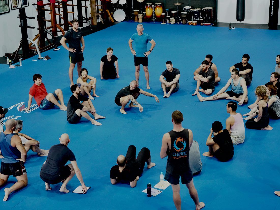Pad work on the mats, coach and student mid combination